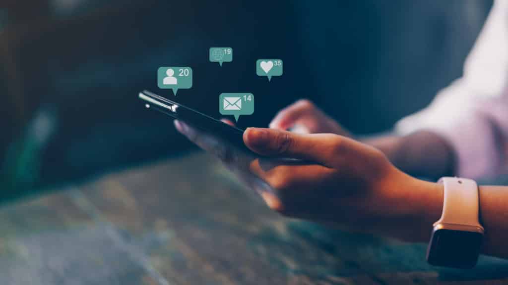 A woman using her smart phone to amplify her social media SEO