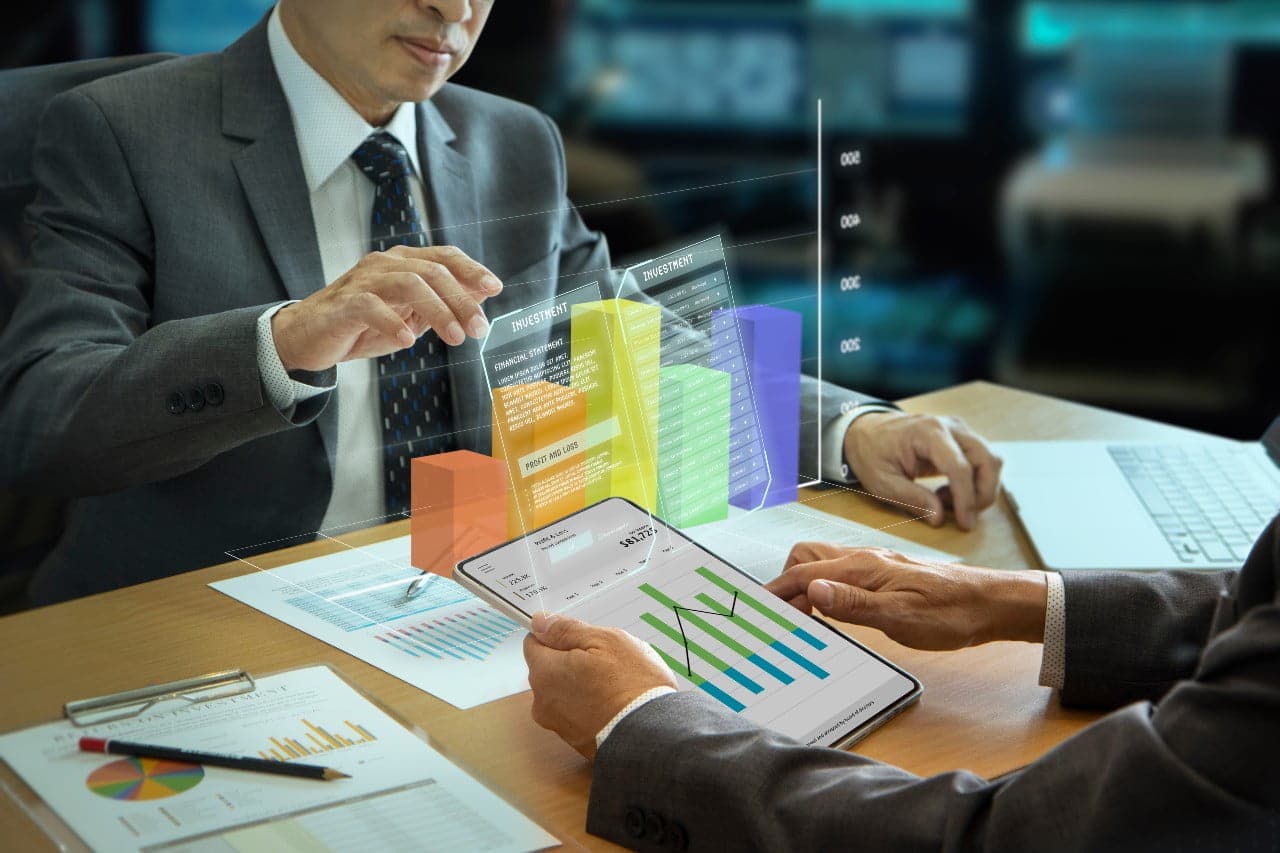 businessmen interacting with augmented reality three-dimentional bar graph while analyzing a return on investment and business performance
