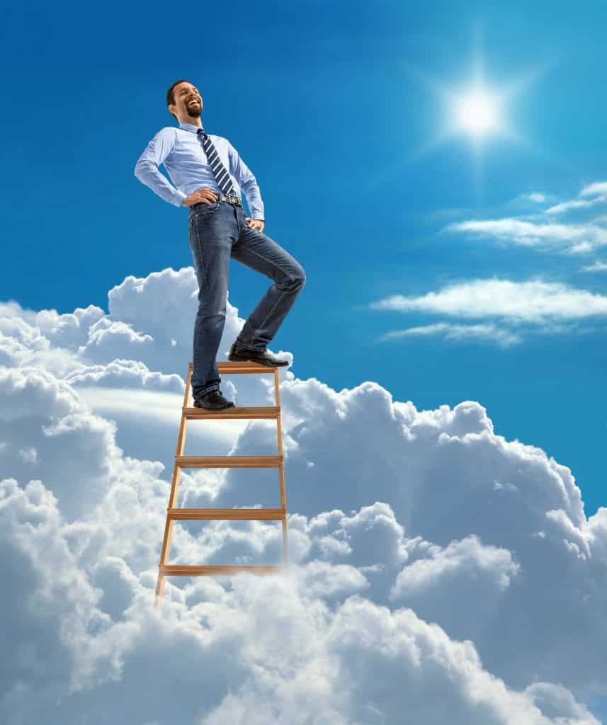 business man on a ladder above the clouds in a blue sky
