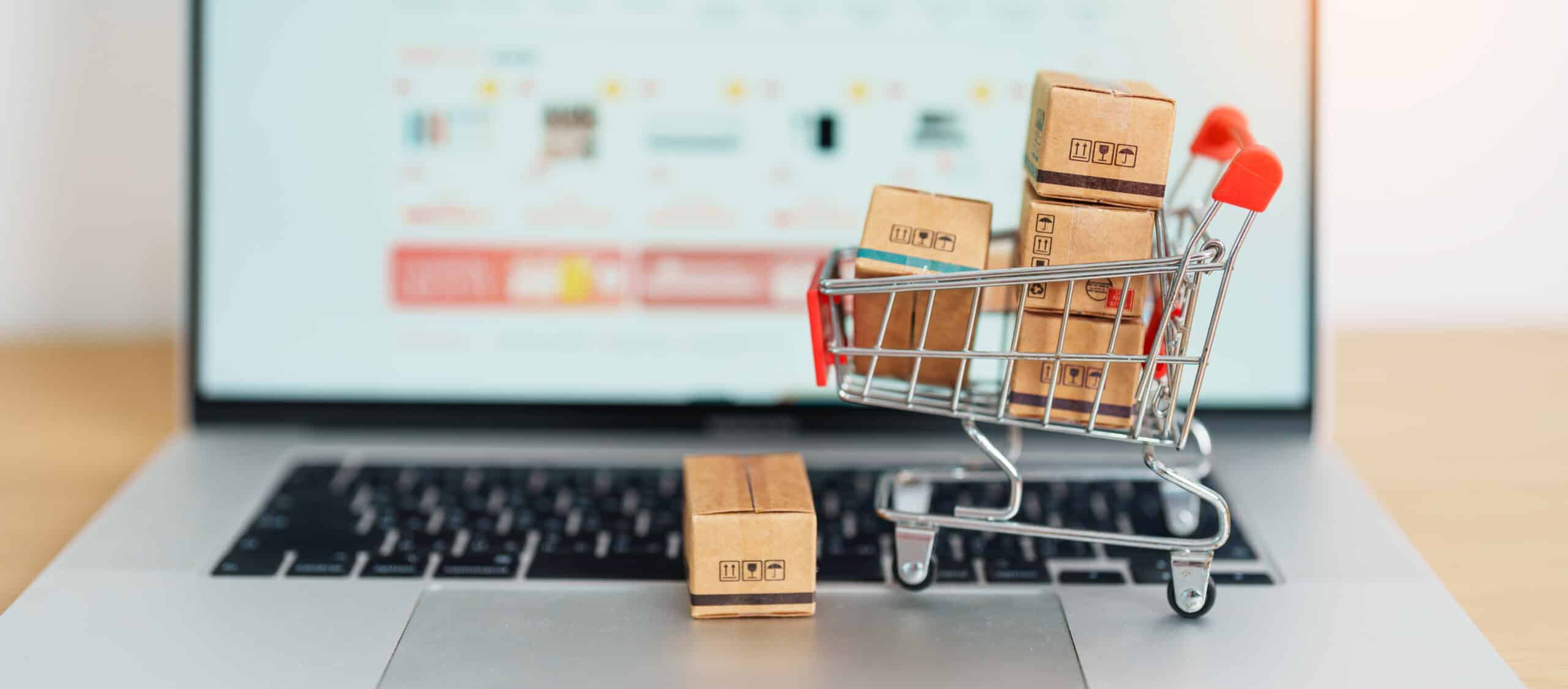 Boxes with shopping cart on a laptop computer. online shopping, Marketplace platform website, technology, ecommerce, shipping delivery, logistics and online payment concepts